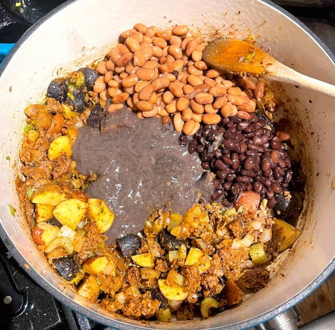 Bean puree and beans added to pot.