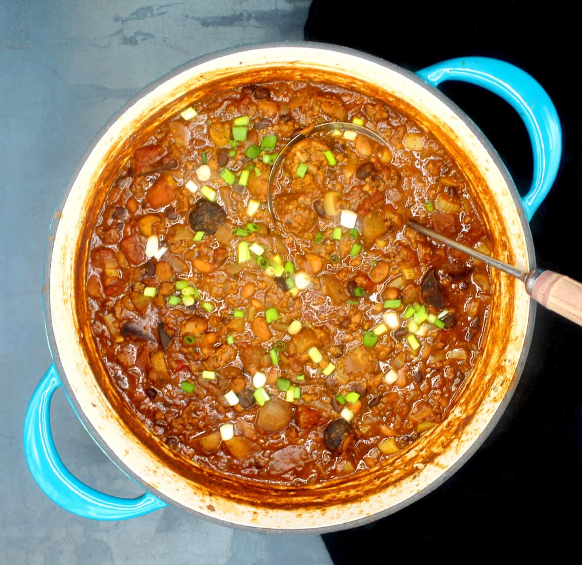 Front overhead shot of a large blue dutch oven with vegan Irish chili.