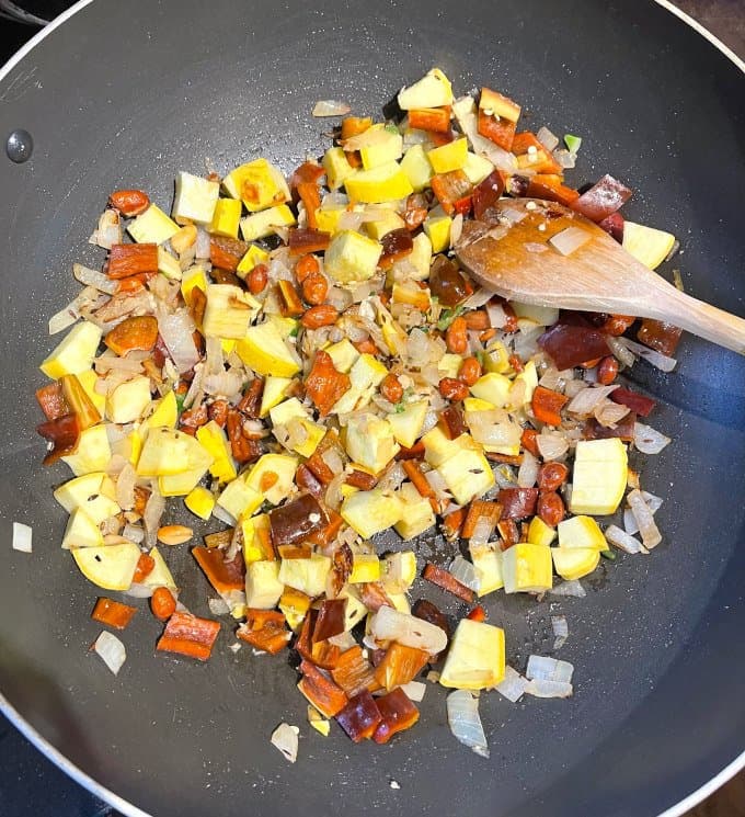 Squash and bell peppers in wok.