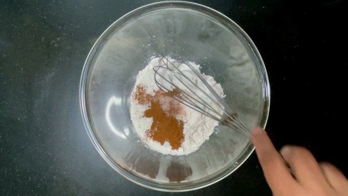 Dry ingredients with whisk in bowl.