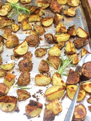 Rosemary roasted potatoes on baking sheet lined with aluminum foil.