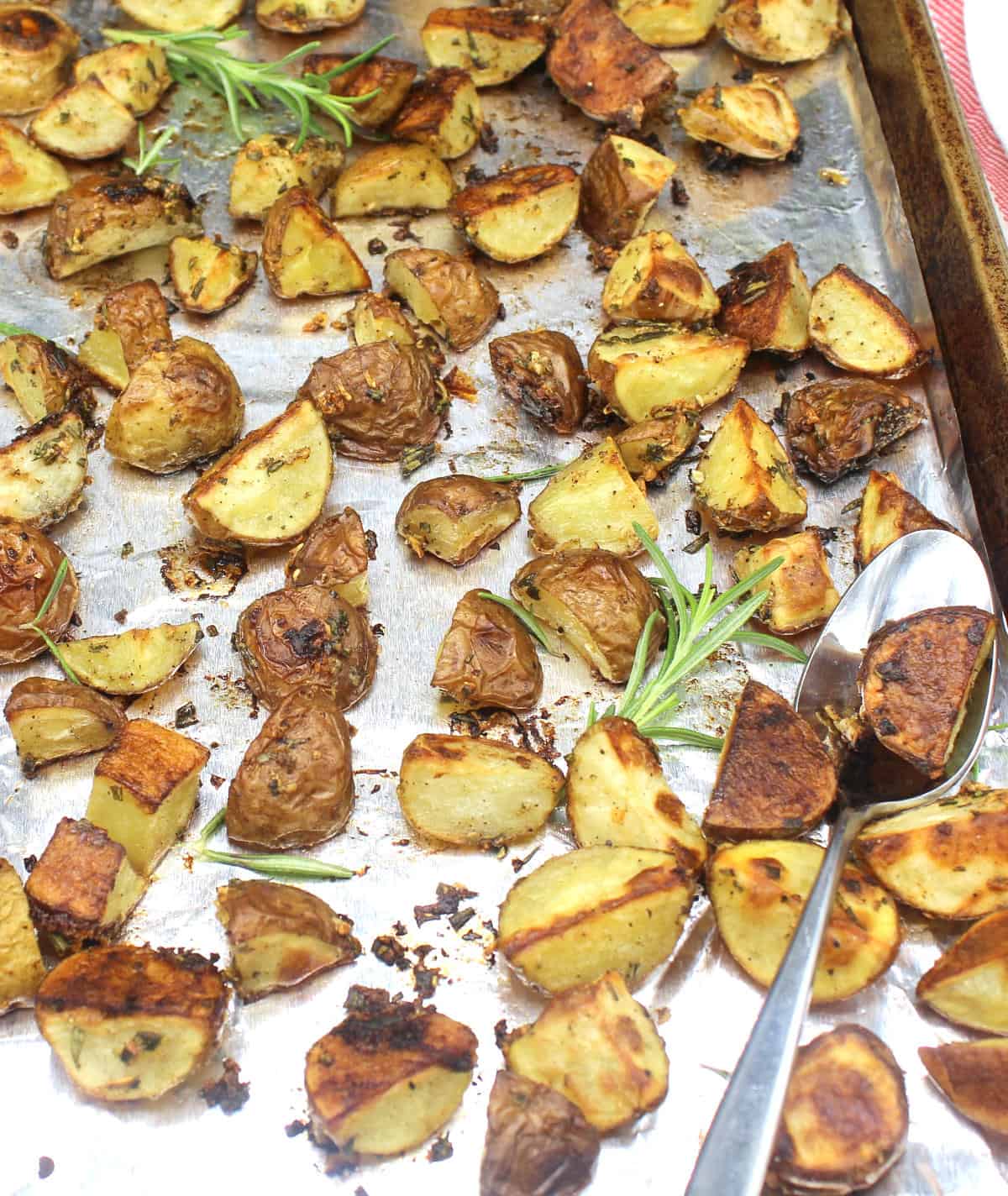 Rosemary roasted potatoes on baking sheet lined with aluminum foil.