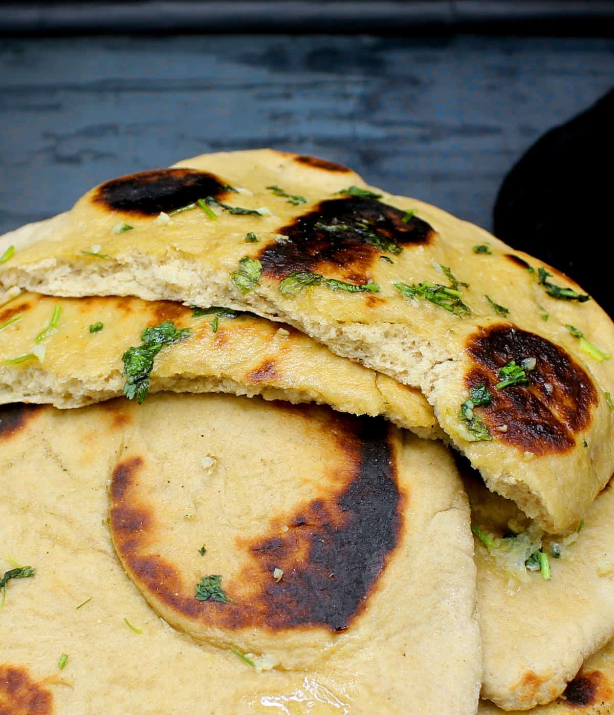 Closeup of a cross section of a puffy, soft, pillowy whole wheat naan.