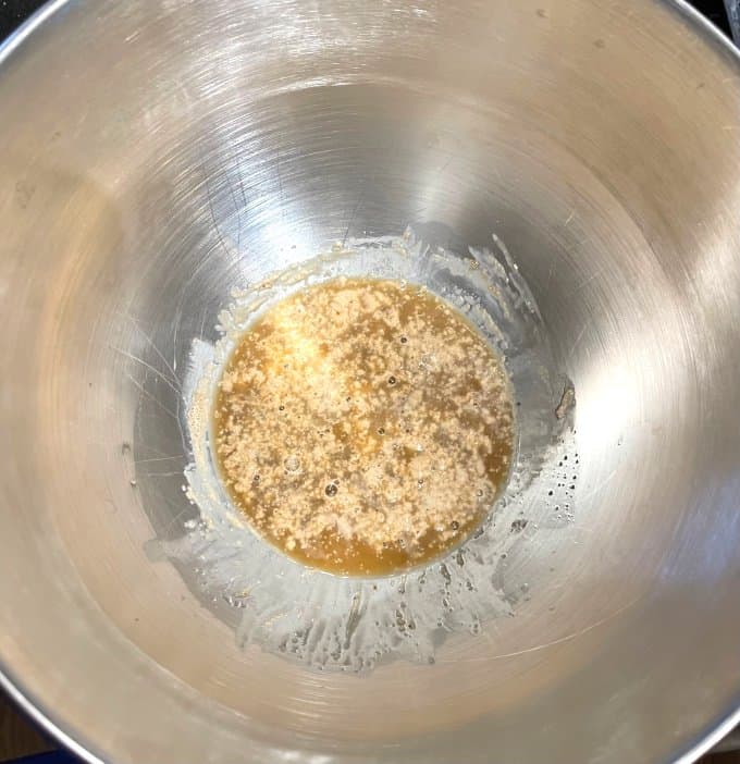 Yeast and sugar with water added in bowl.
