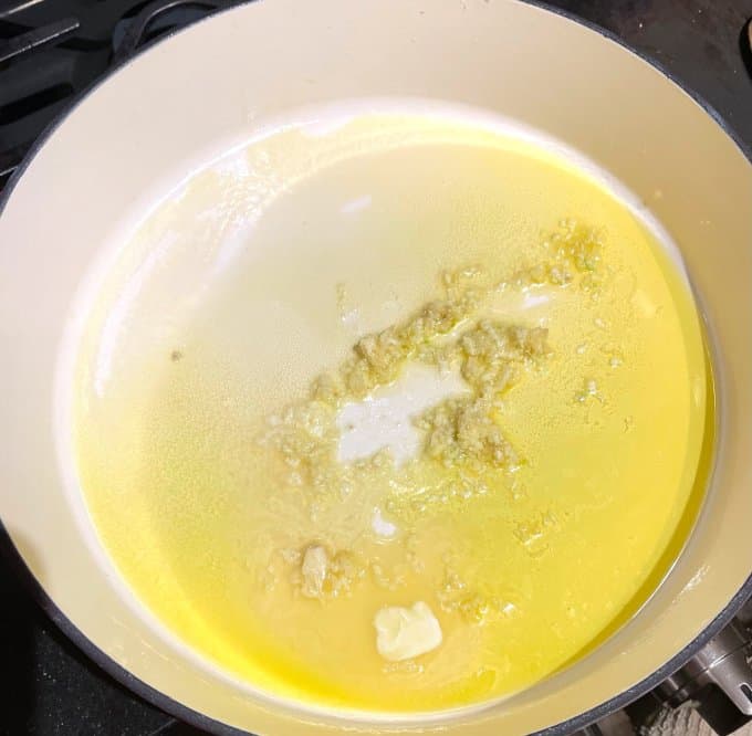 Garlic in butter and olive oil in large skillet.