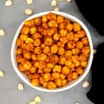 Crispy air fryer chickpeas in gray bowl with chickpeas scattered around.