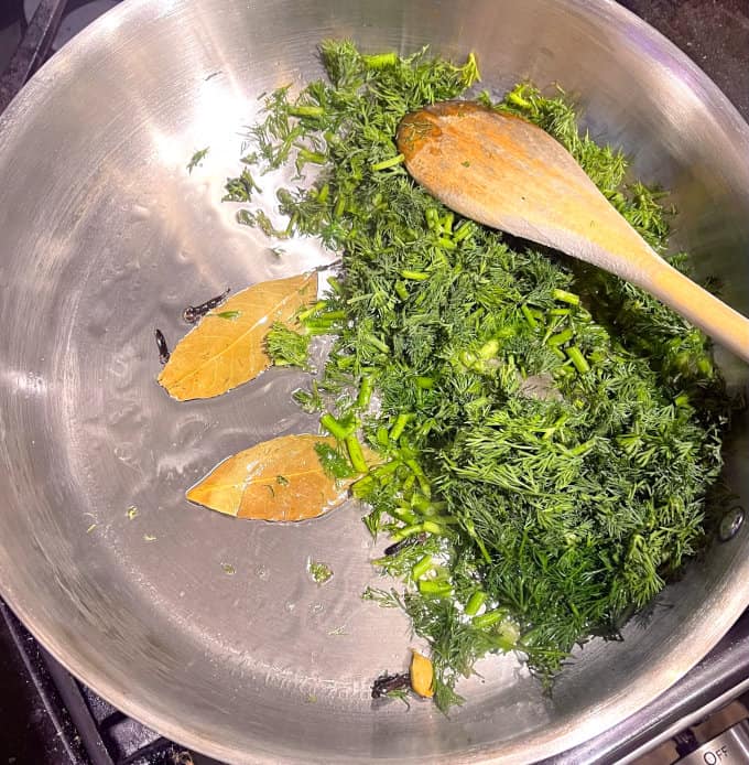 Dill added to skillet with oil and spice.