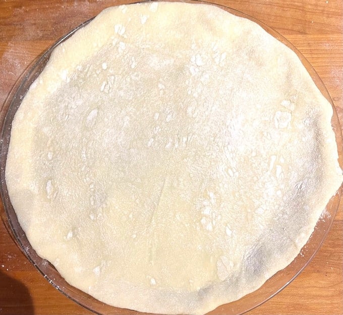 Top crust fitted over pithiviers filling.