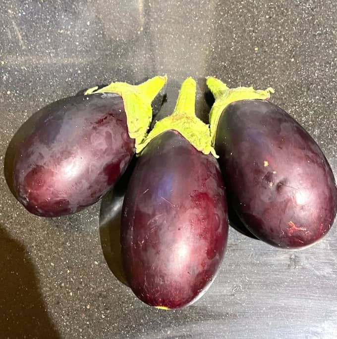 Three plump eggplants.