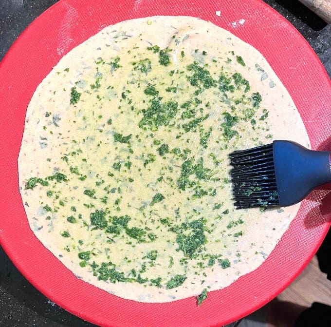 Brushing mint oil over the rolled paratha.