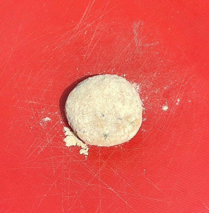 Ball of dough on rolling board.