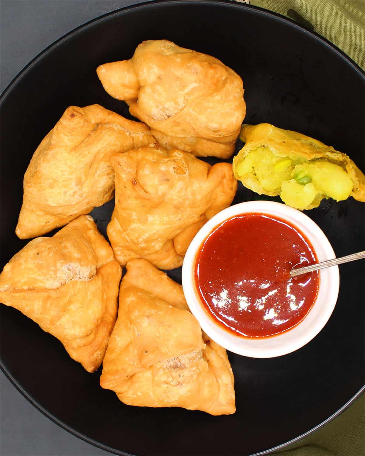 Samosas in plate with chutney.