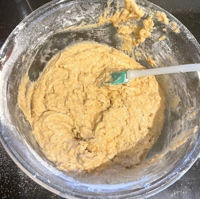 Cake batter in mixing bowl with spatula.