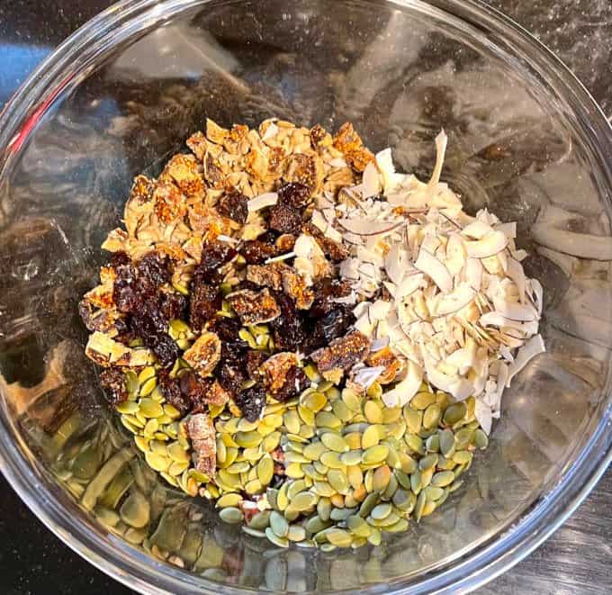 Nuts and seeds for granola in large glass mixing bowl.