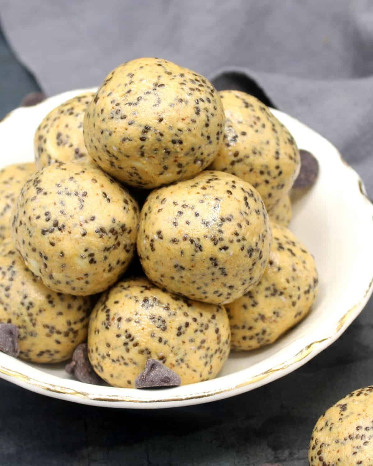 Vegan protein energy bites with peanut butter and chia seeds in a white bowl.