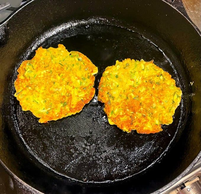 Vegan courgette fritters in skillet.