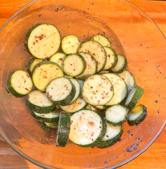 Zucchini with flaxseed mixed in bowl.