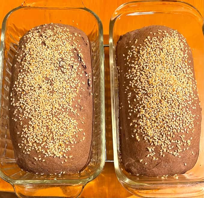 Baked loaves of whole wheat low carb bread in glass loaf pans.