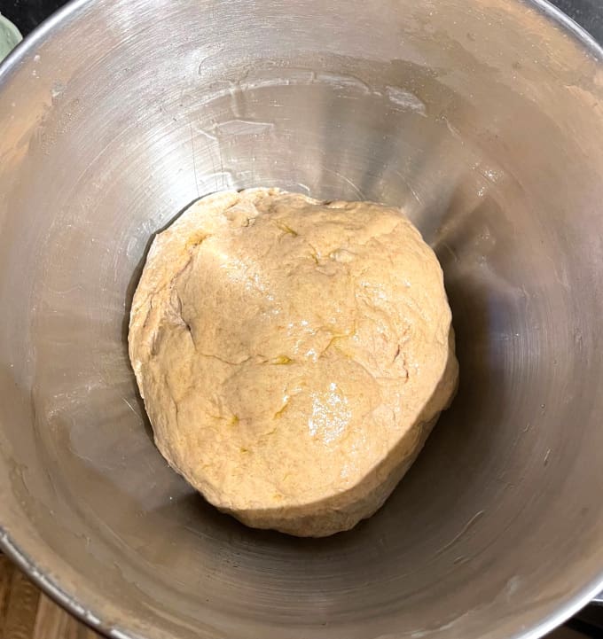 Dough formed into a ball in bowl.