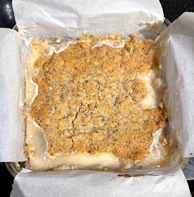 Baked keto blondies in baking dish lined with parchment paper.