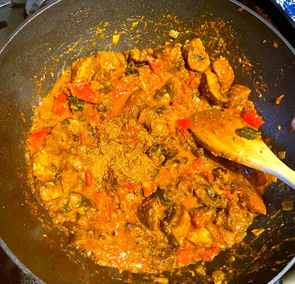 Mushrooms added to curry sauce.