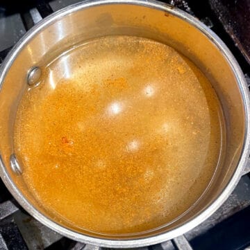 Chai masala and sugar added to saucepan with water/masala chai tea