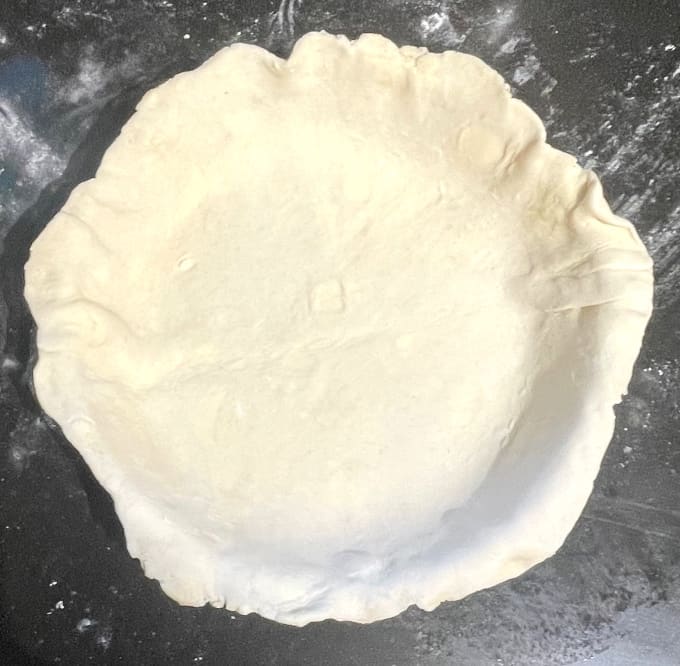 pie dough fitted in deep dish pie plate.