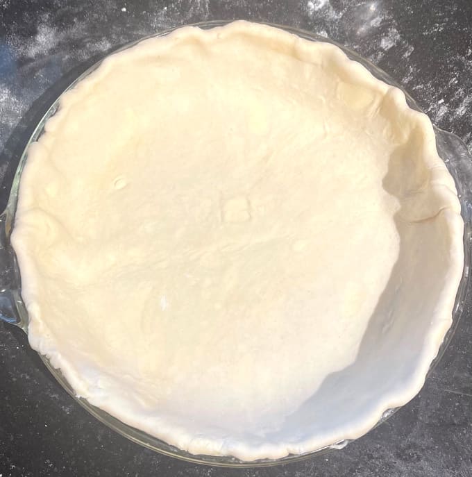 Pie dough with overhang tucked in.