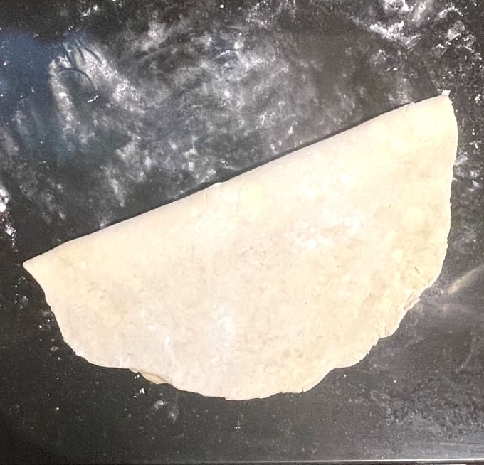 Pie dough folded in half.