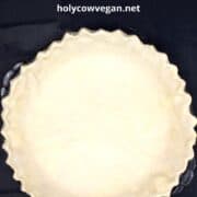 Vegan pie crust in pie plate with text inlay that says "flaky vegan pie crust, holycowvegan.net"