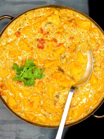 Easy butternut squash curry in pan with spoon.