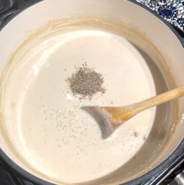 Cardamom added to kheer in dutch oven.