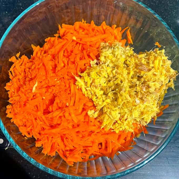 Carrot and ginger, grated, in bowl.