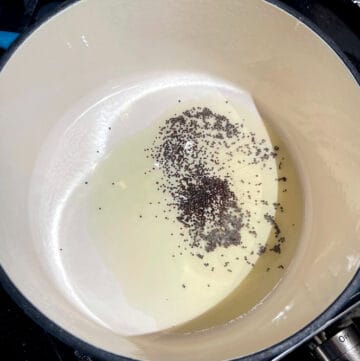 Mustard seeds sputtering in Dutch oven.