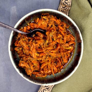 Pickled carrots or gajar ka achar in bowl.