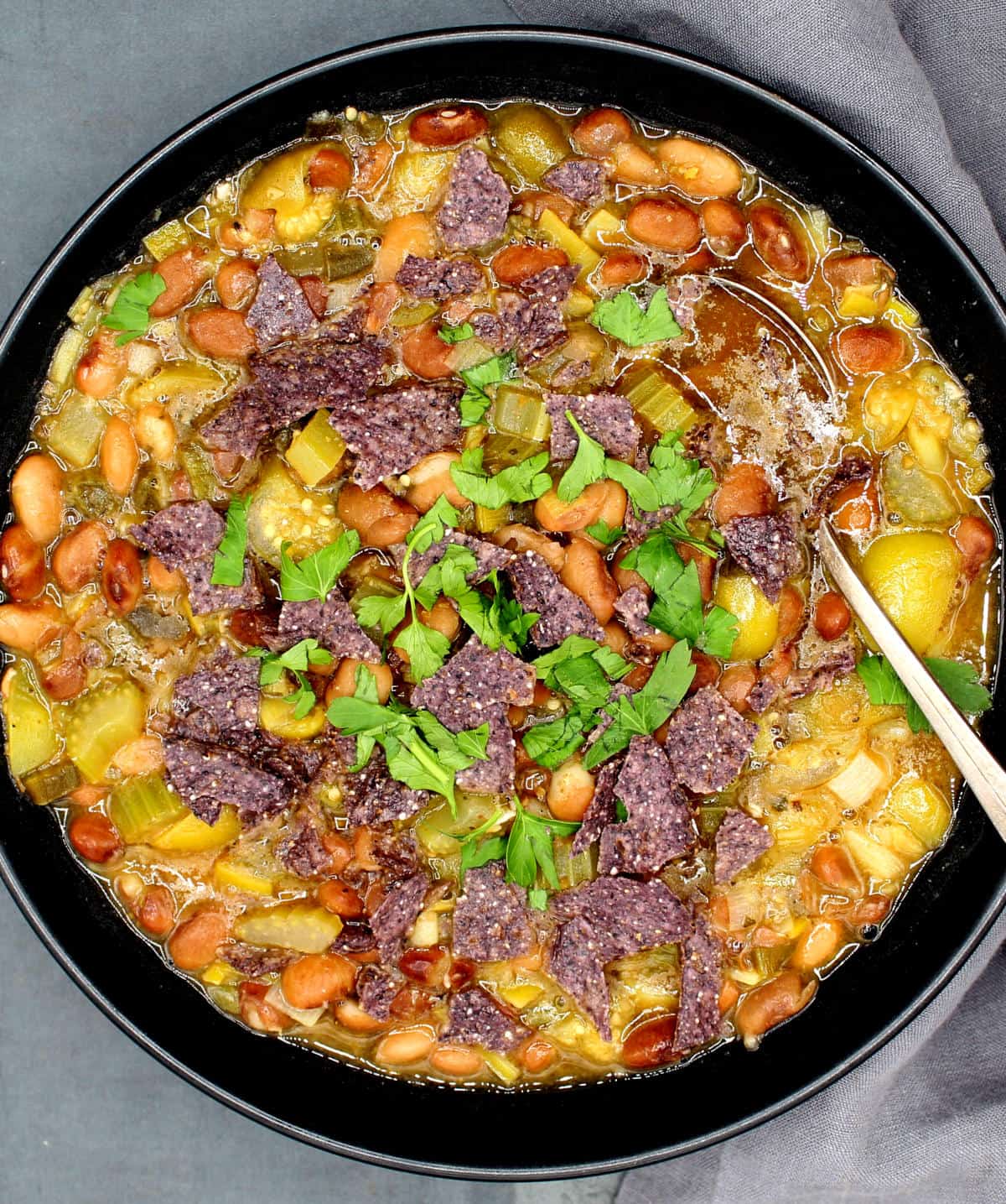 A bowl with vegan pinto bean tomatillo stew.