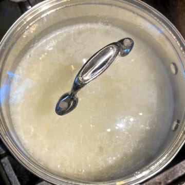 Rice in saucepan with lid.