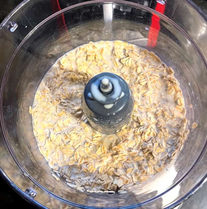 Old fashion rolled oats soaking in milk in food processor bowl.
