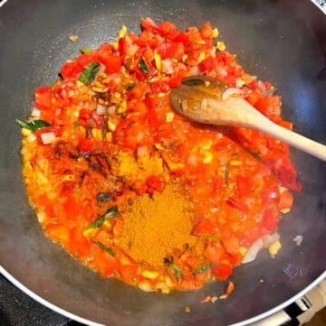 Spices added to tomatoes and onions for tomato rice.