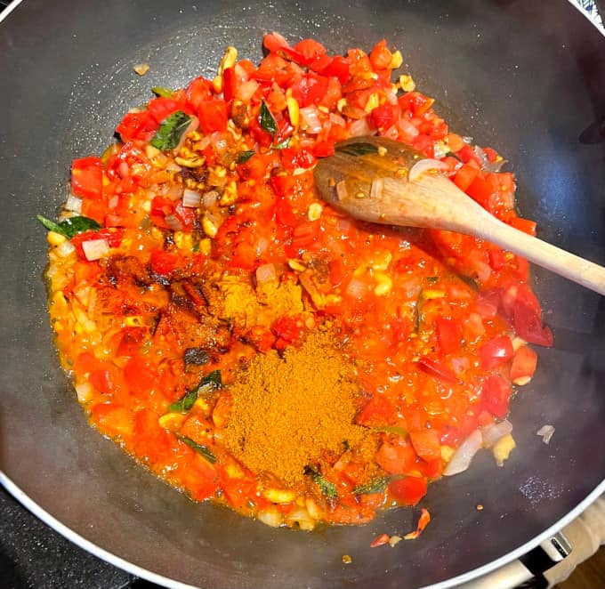 Spices added to tomatoes and onions for tomato rice.