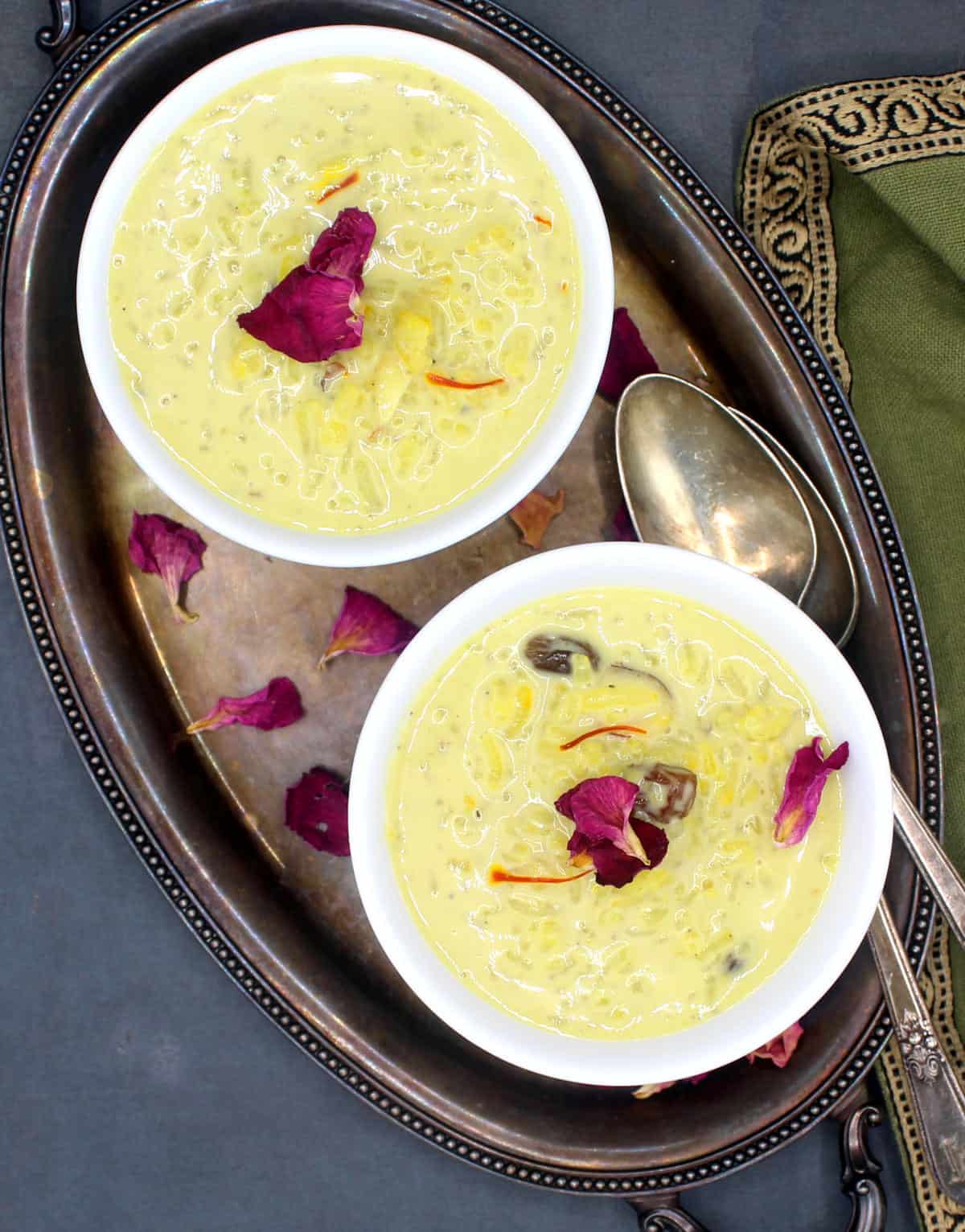 Vegan rice kheer in white bowls with rose petal garnish.