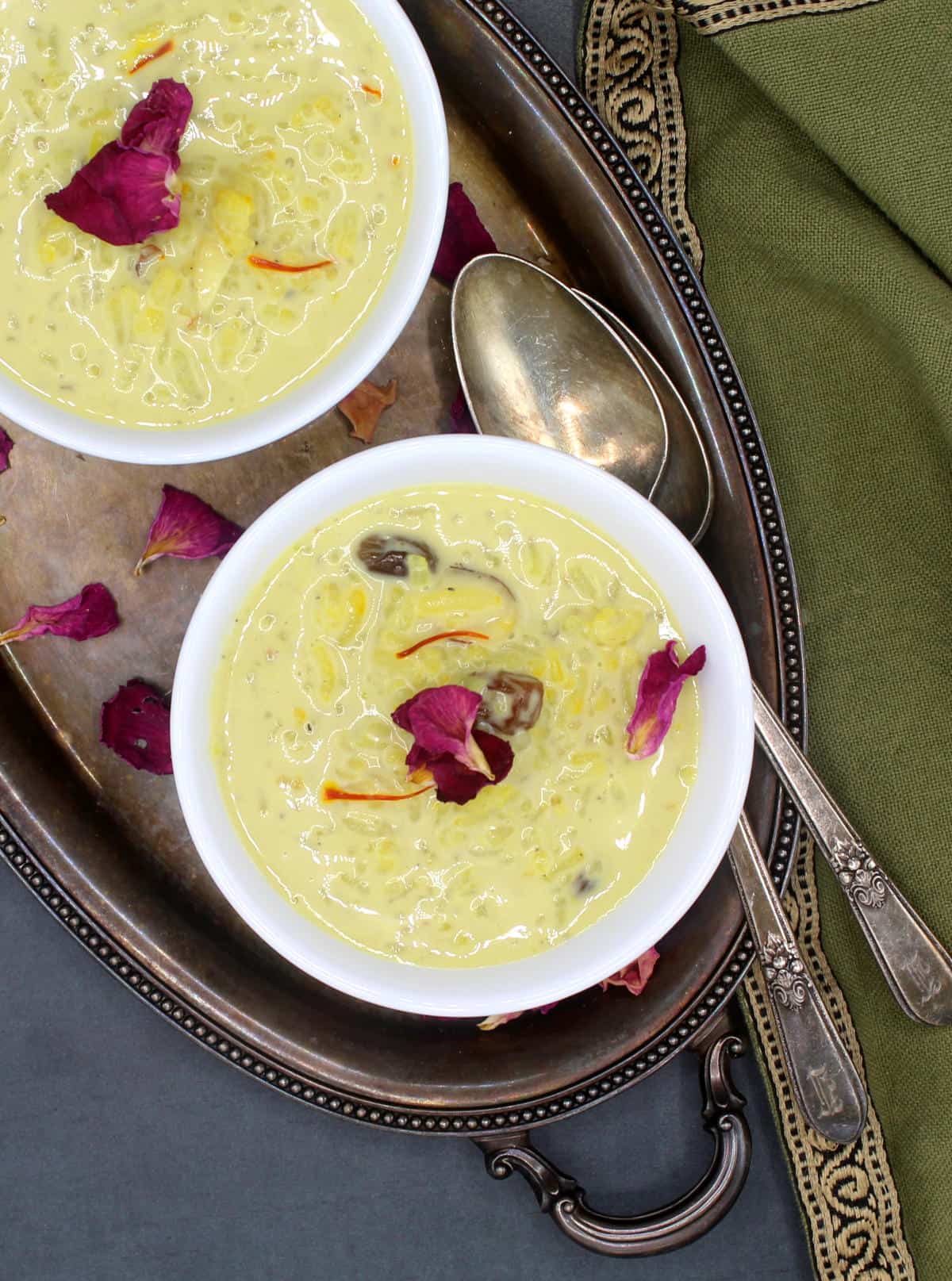 Vegan kheer in white bowls with rose petals.