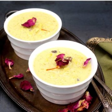 White bowls with vegan kheer or Indian rice pudding and rose petals for garnish.