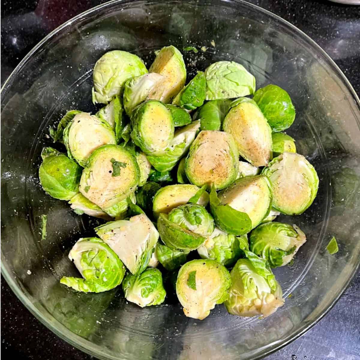 Seasoned Brussels sprouts in bowl.