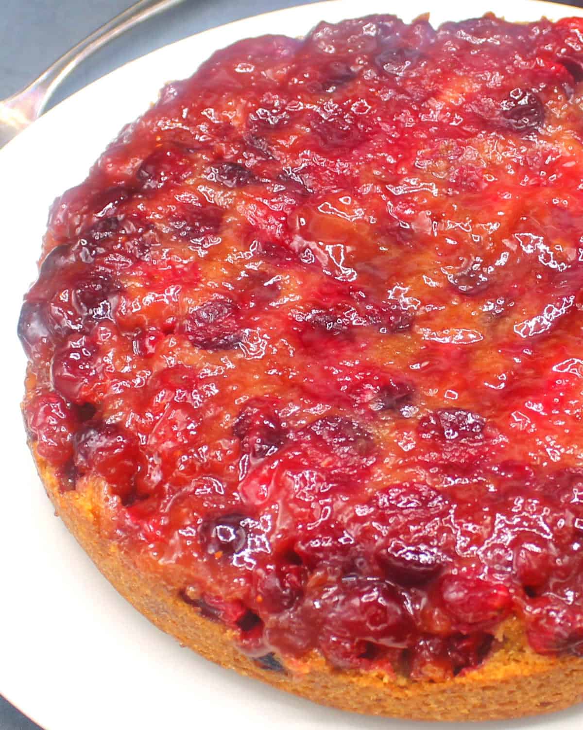 Vegan cranberry upside down cake on a white plate.