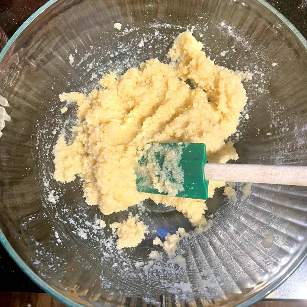 Vegan amaretti cookie dough in bowl with spatula.