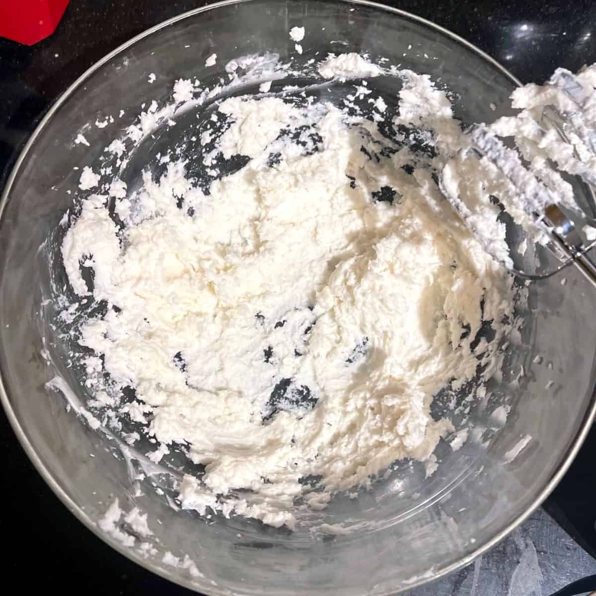 Vegan butter and cream cheese creamed together in bowl.