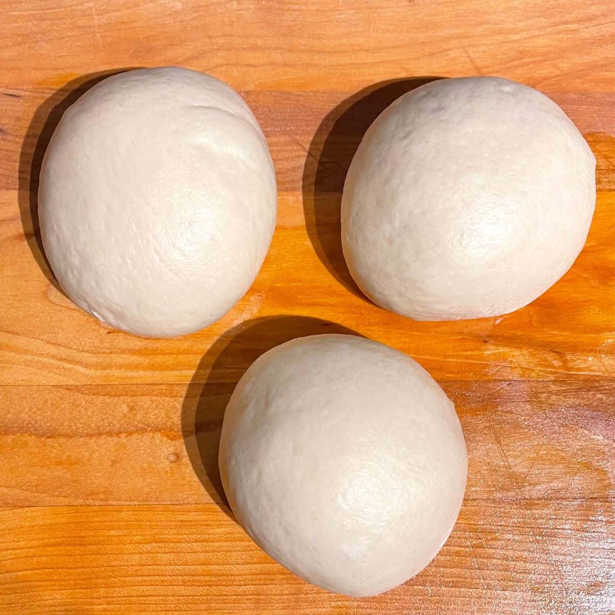 Three balls of vegan challah dough,