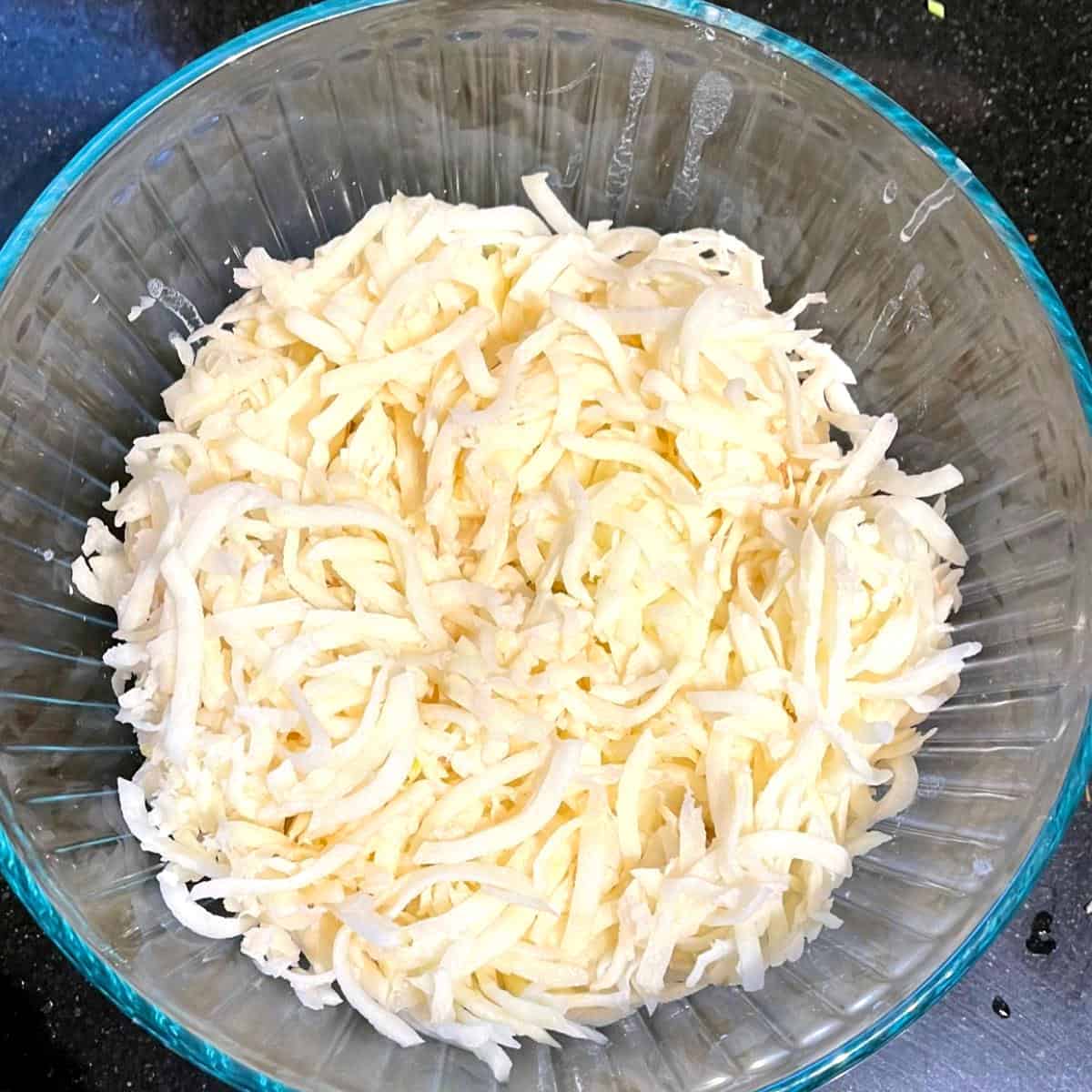 Grated potatoes in bowl.