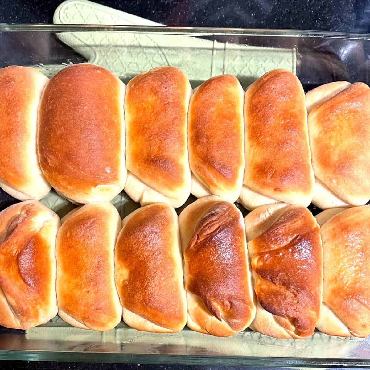 Baked vegan Parker House rolls in baking dish.